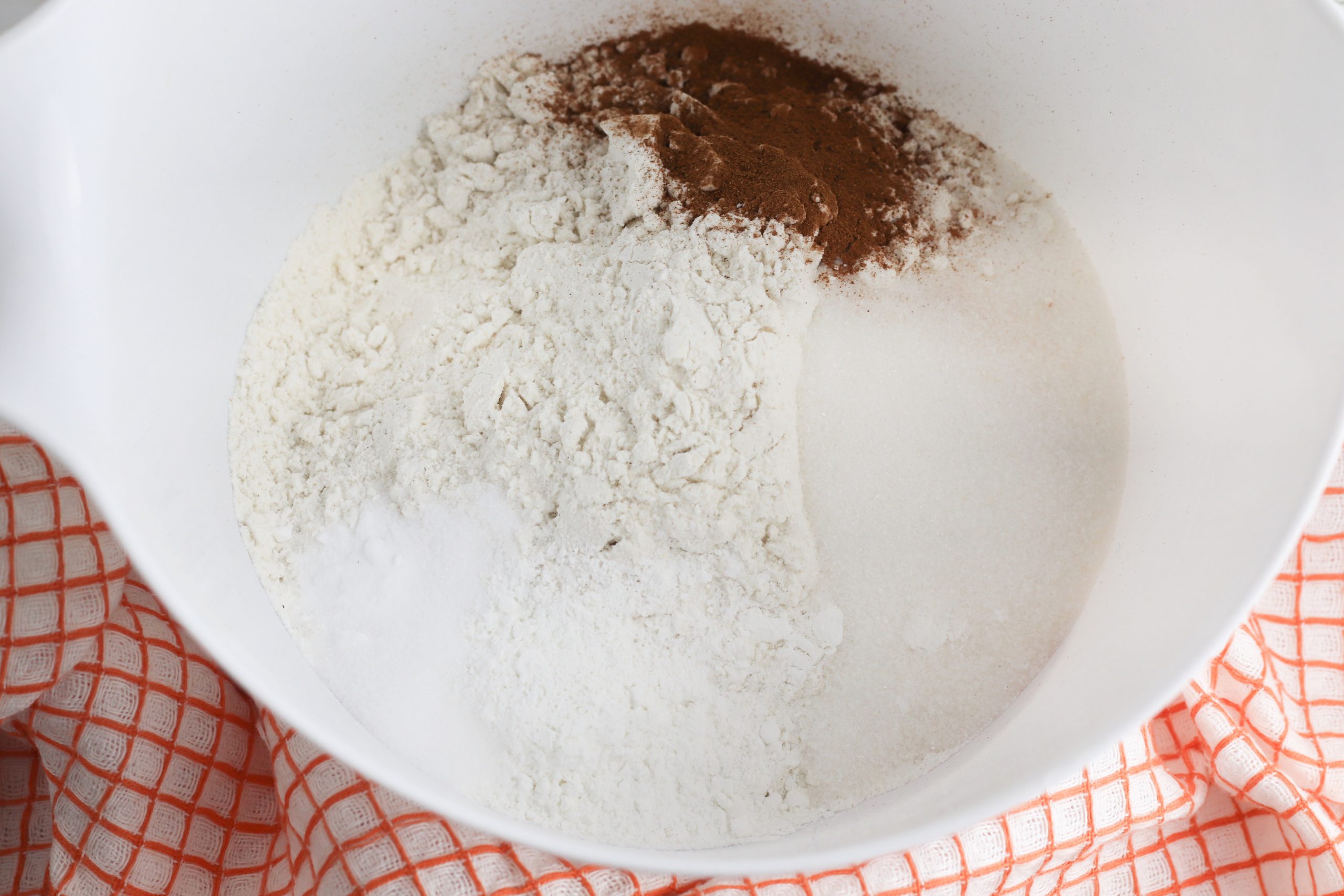 flour, sugar, baking powder, baking soda, pumpkin pie spice, and salt in a bowl