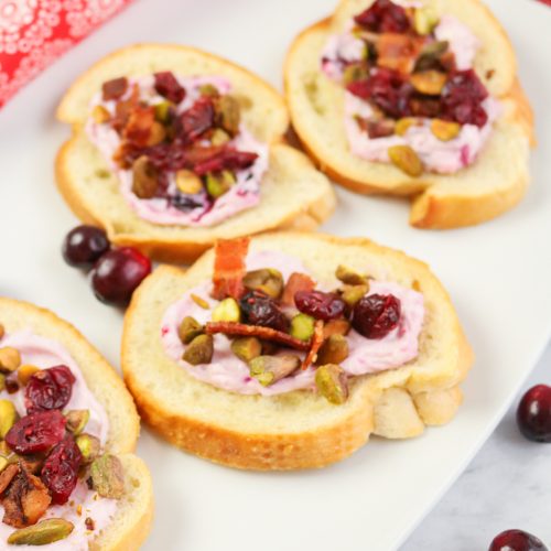 Bacon Pistachio and Cranberry Cream Cheese Crostini on a plate