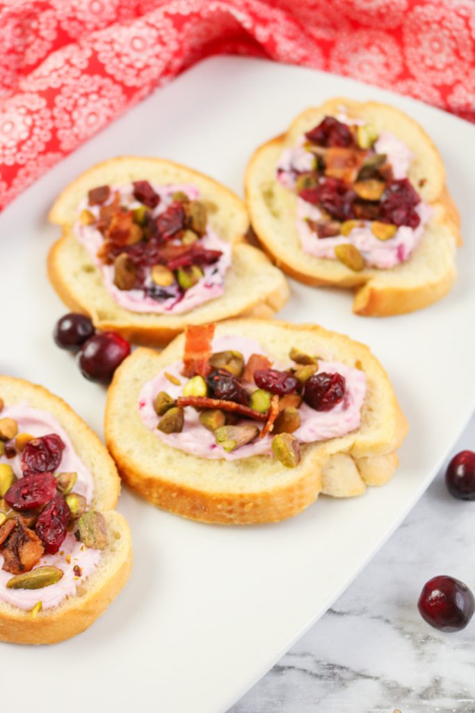 Bacon Pistachio and Cranberry Cream Cheese Crostini on a plate