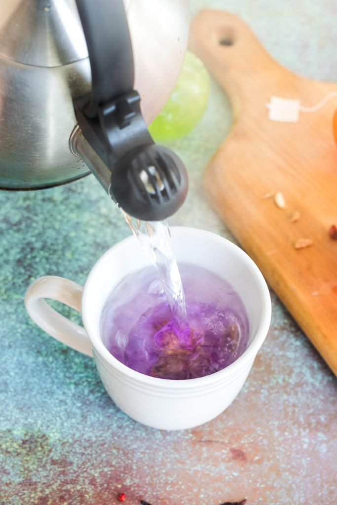 pouring hot water over tea bomb