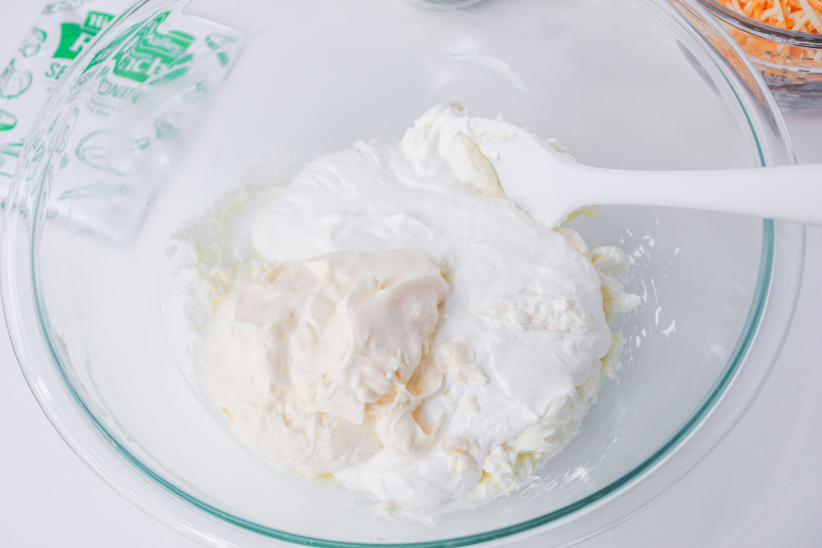 cream cheese, butter, sour cream and mayonnaise in a bowl