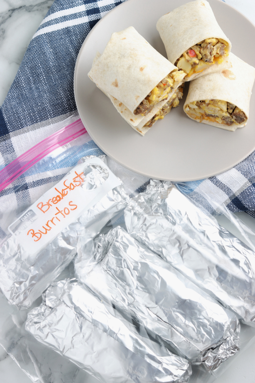 Fully Loaded Breakfast Burritos on a plate and wrapped in foil