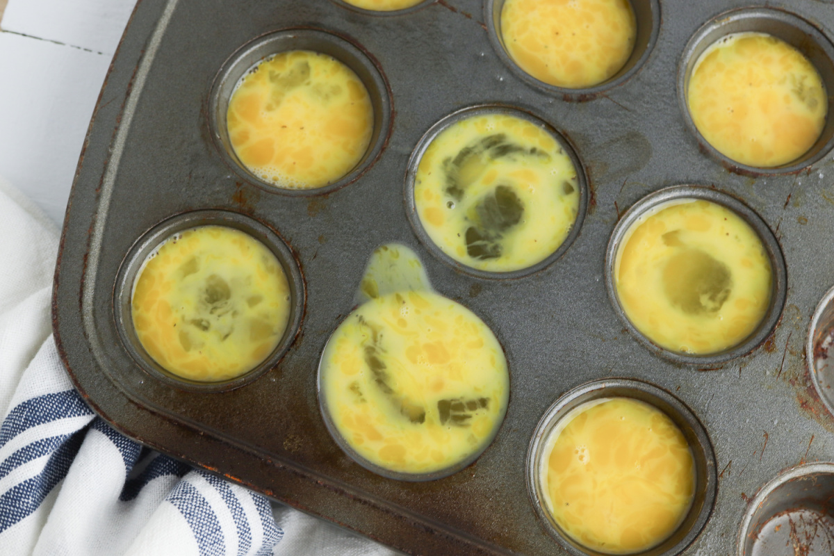 mixed eggs placed in mini muffin pan