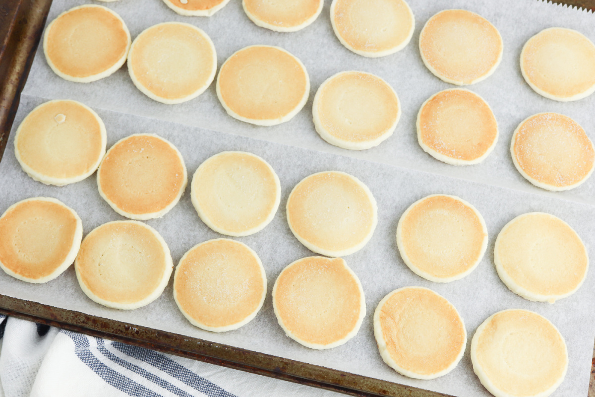 mini pancakes laid out on a baking sheer