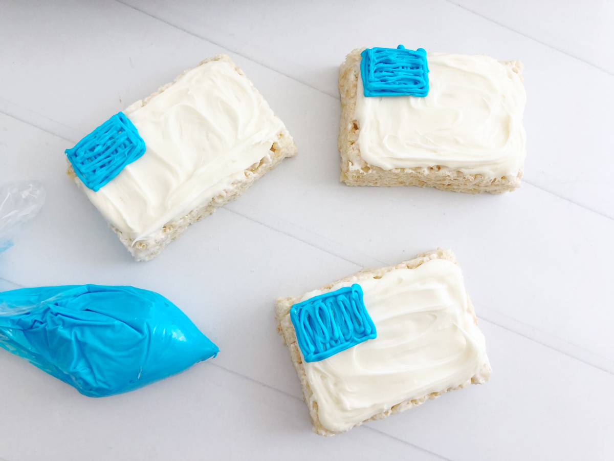 white and blue frosting added to top of rice krispie treats