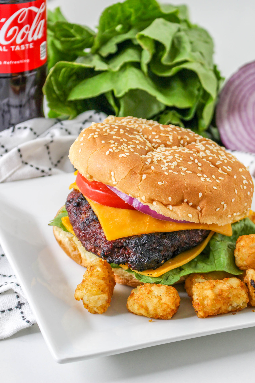 Coca Cola Burger on a plate with tater tots