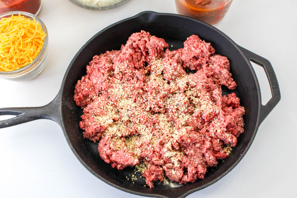 seasoning beef in a pan