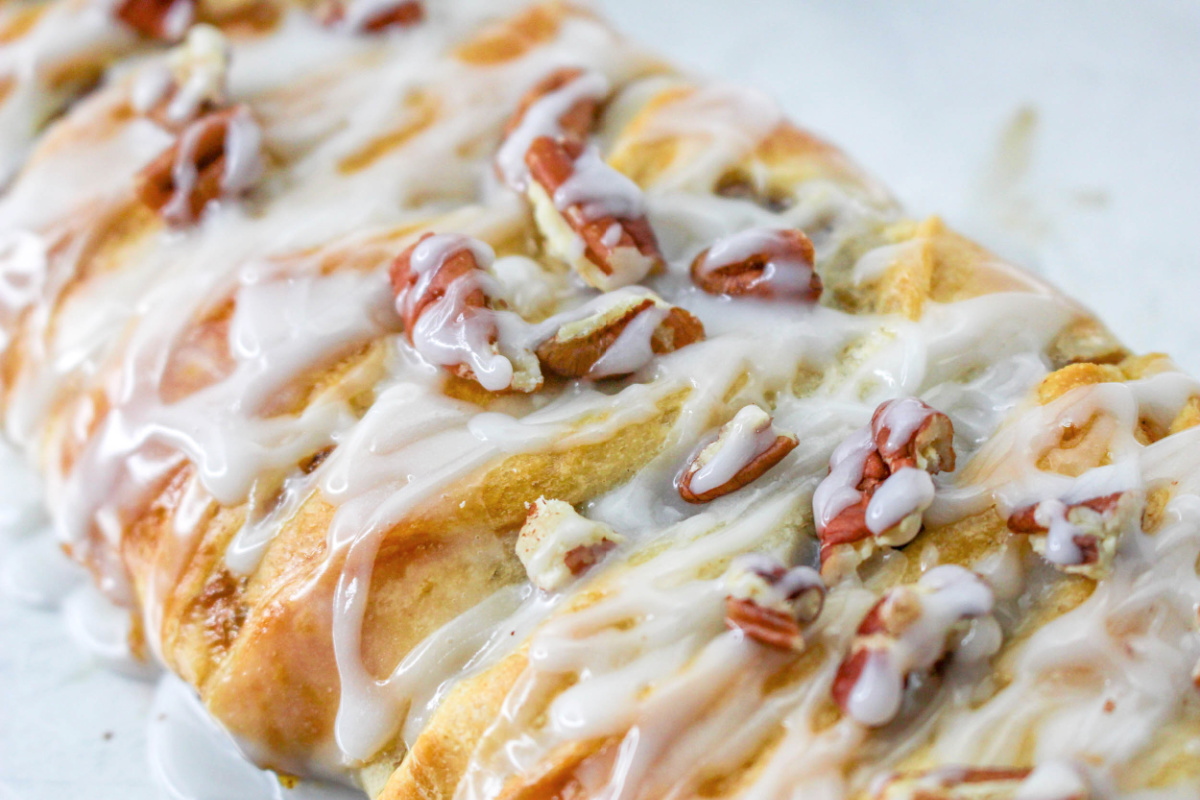 Easy Pumpkin Pecan Braid topped with icing and nuts