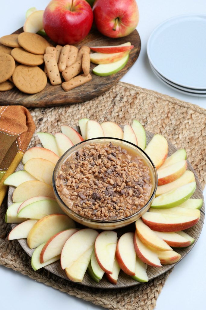 Cream Cheese Caramel Apple Dip with Toffee Bits in a bowl with apples