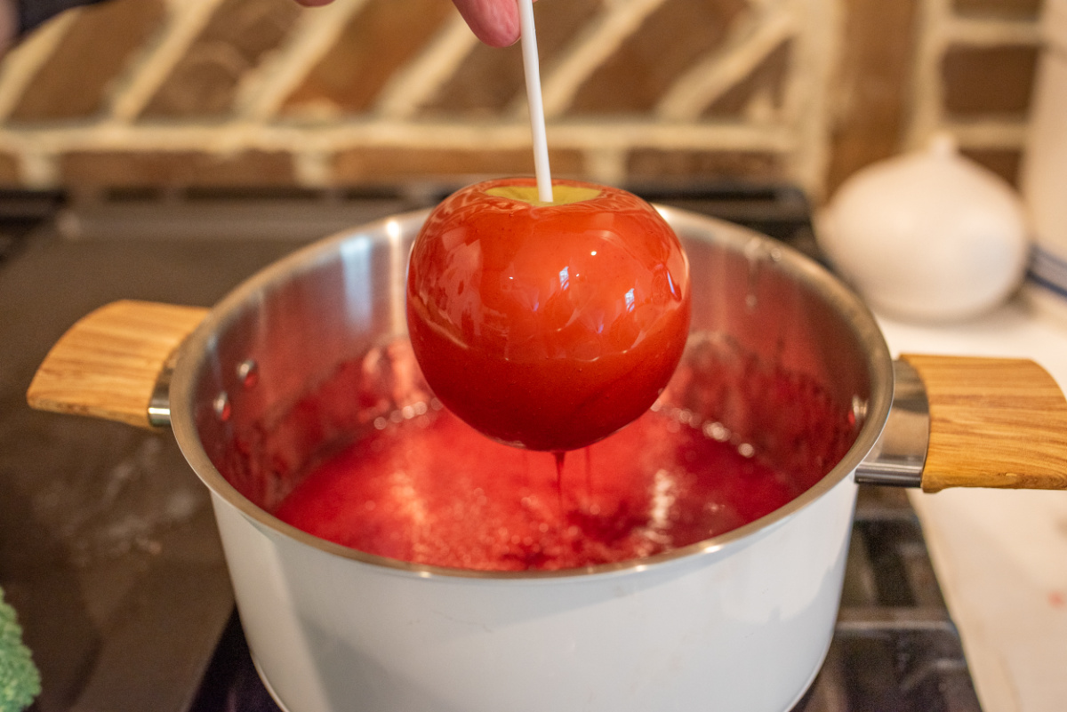 dipping apple into candy mixture