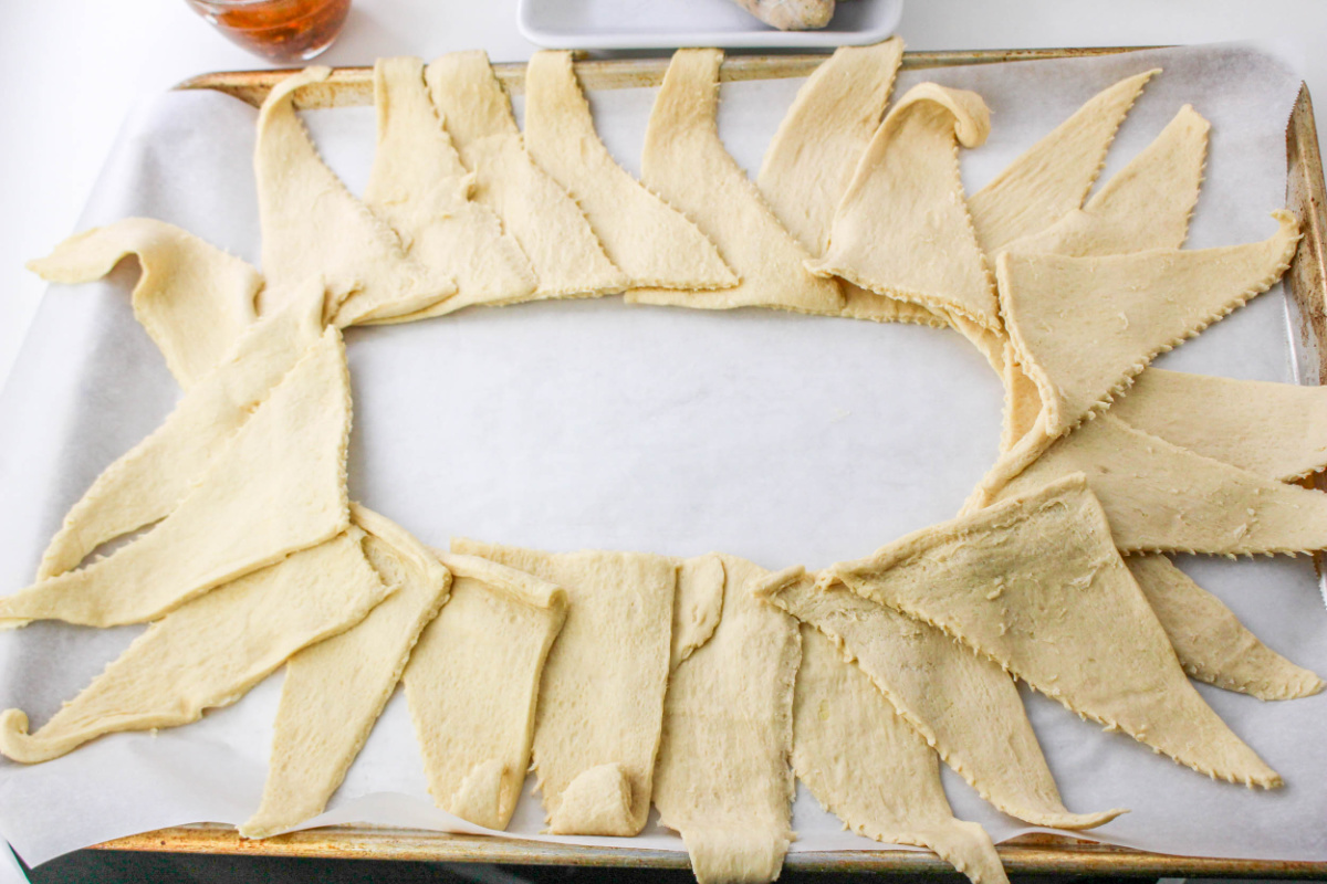 crescent dough triangles laid out on baking sheet