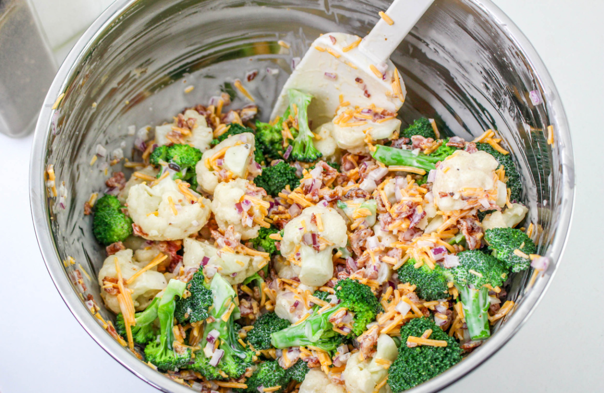 stirring amish broccoli salad in a bowl