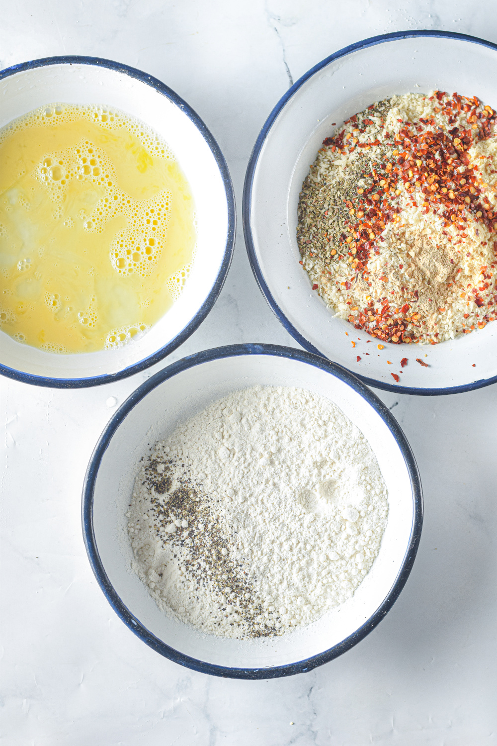  seasonings, flour and egg wash in bowls