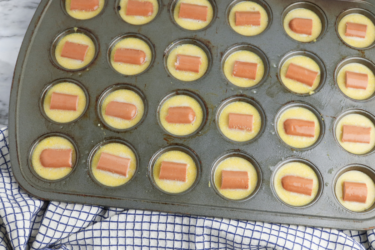 hotdog pieces placed in muffin tin