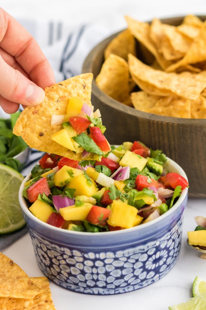 Fresh Mango Salsa in a small bowl with a chip
