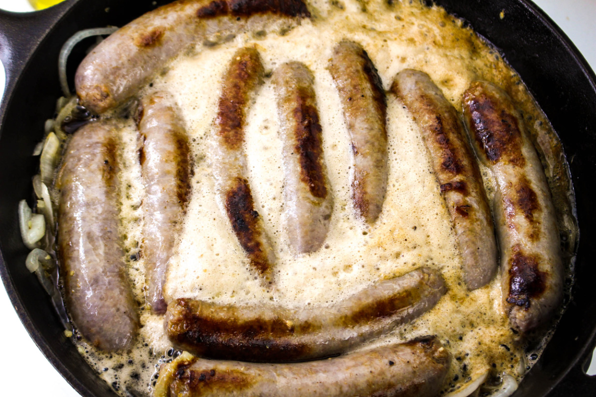 brats simmering in pan with beer