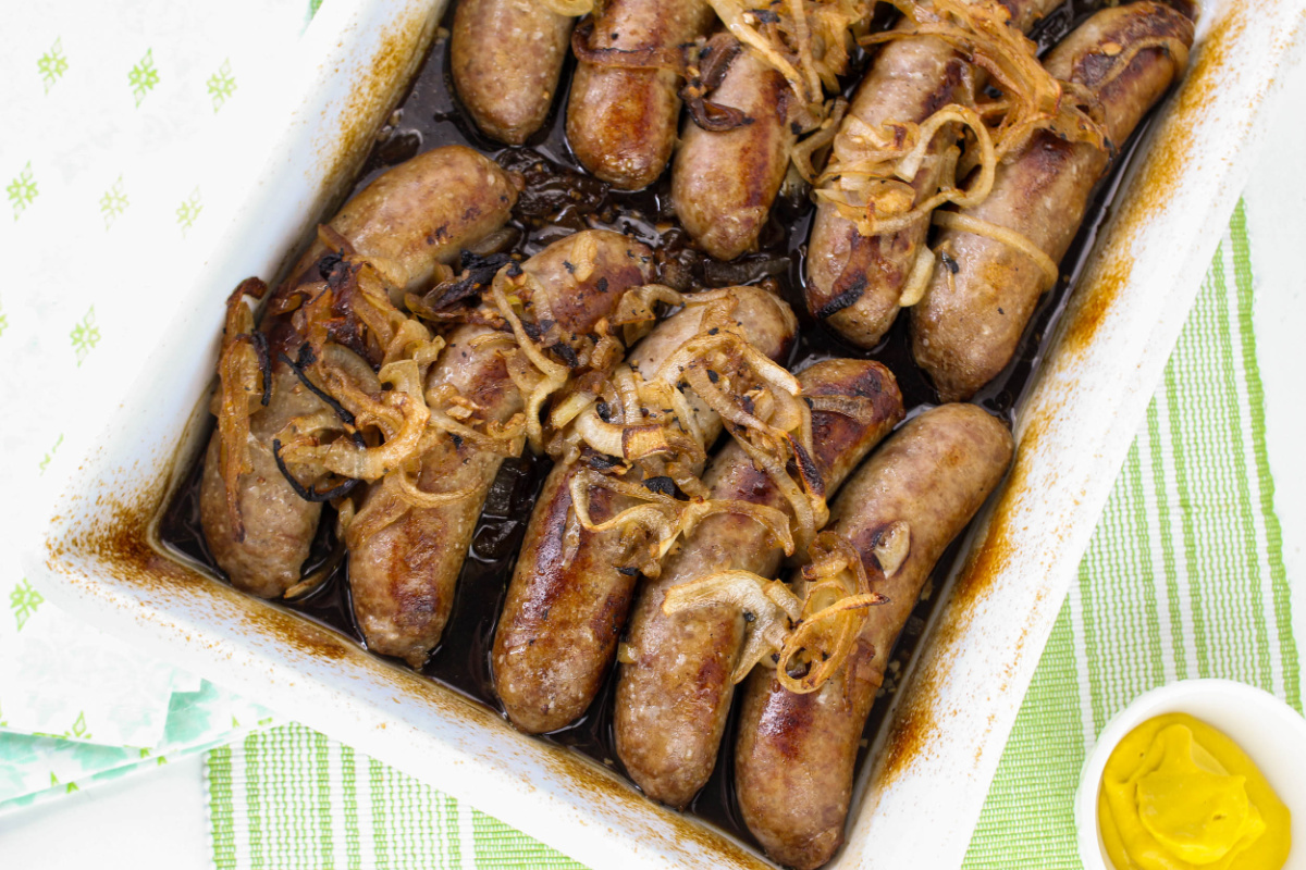 cooked brats in baking dish