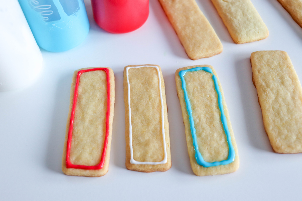 frosting outlined on cookies