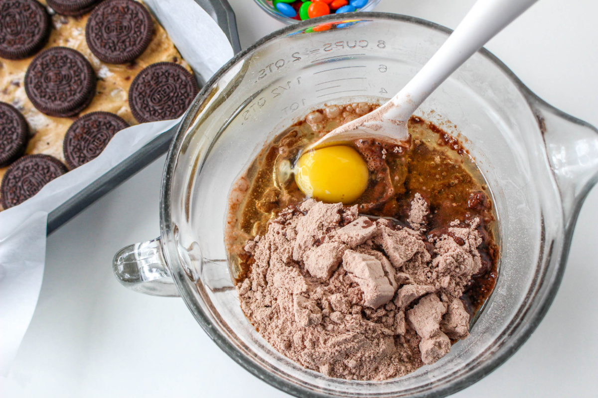 mixing ingredients for brownie batter in a bowl