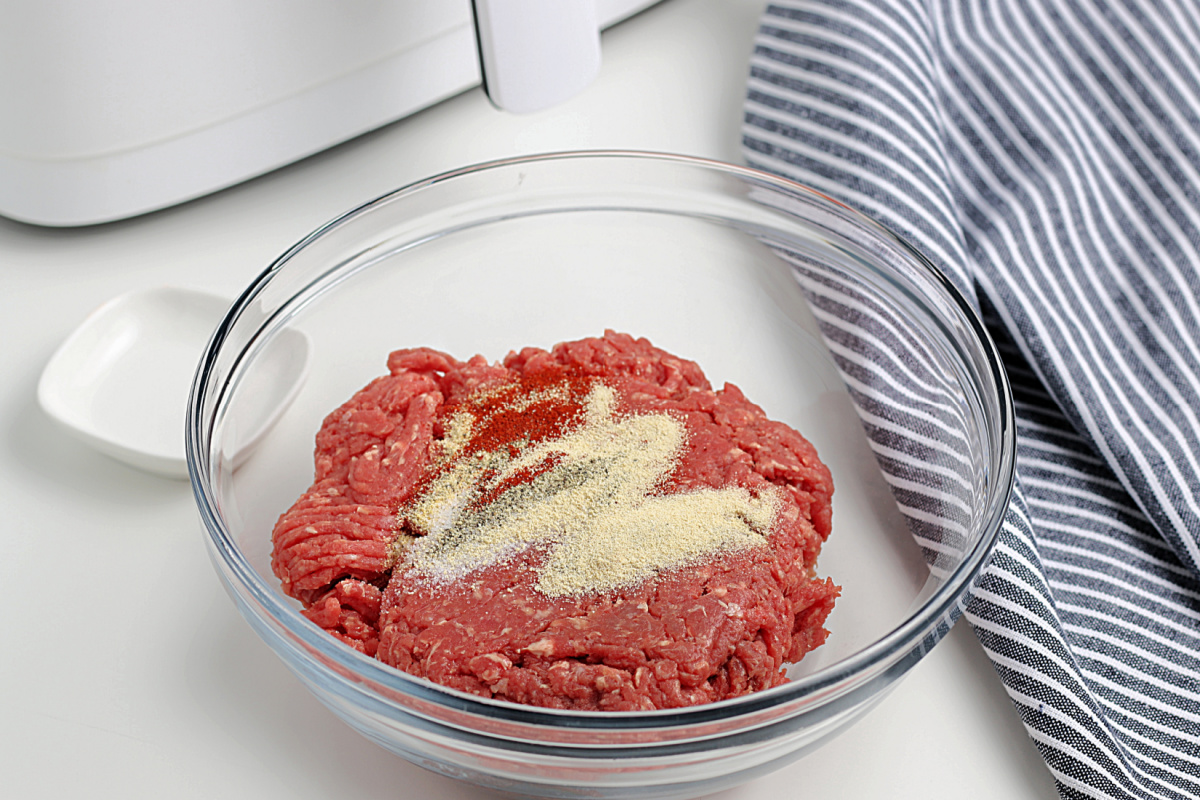 seasoning and group beef in a bowl