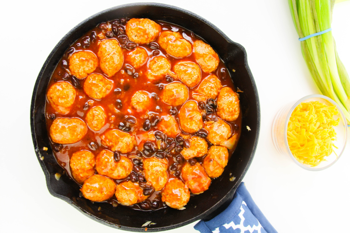 black beans, sauce and meatballs added to pan