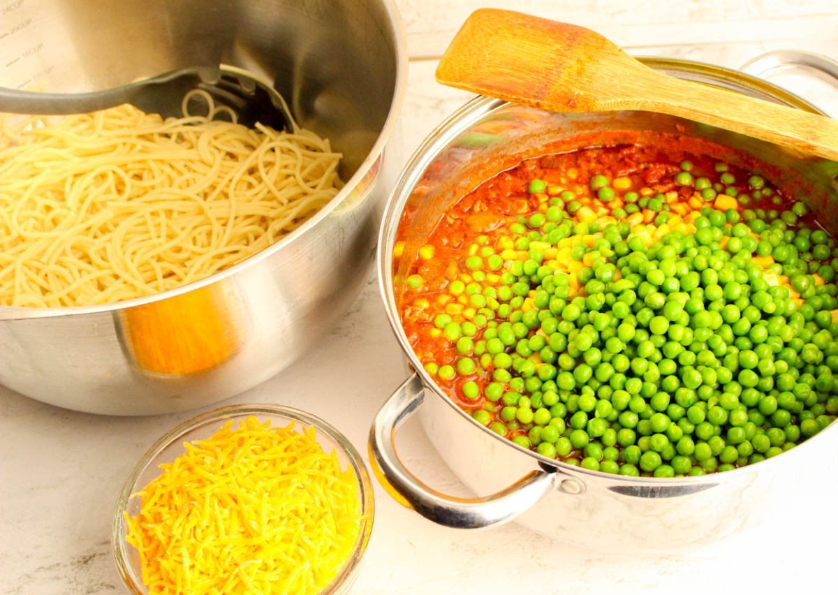 mixing in vegetables and tomatoes