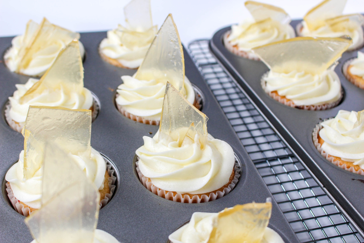 sugar glass placed on top of cupcakes