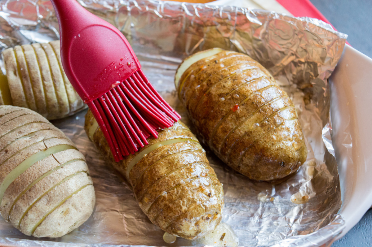 brushing potatoes with dressing mixture