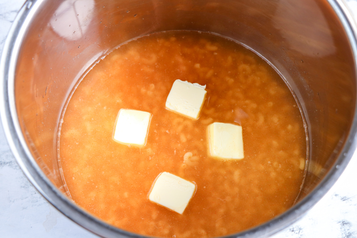 macaroni pasta, water, butter, salt, ground mustard, and smoked paprika into the Instant Pot.