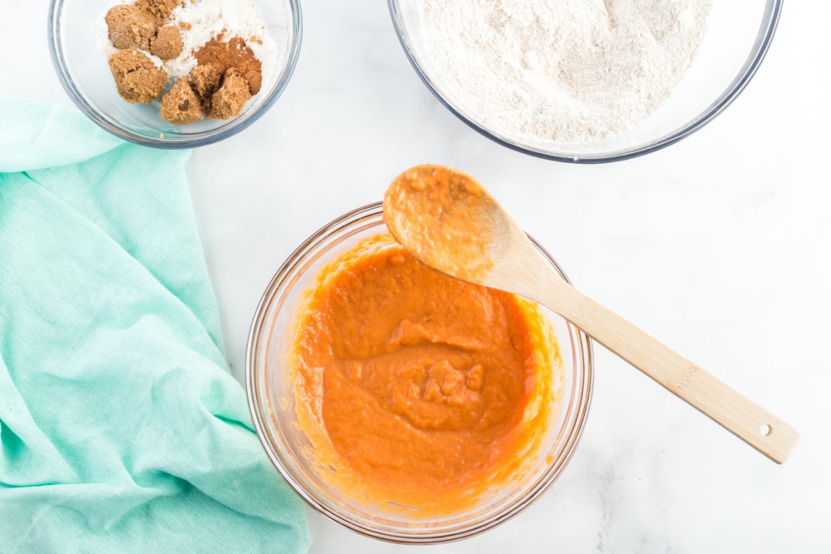 vegetable oil, pumpkin, milk and eggs mixed in a bowl