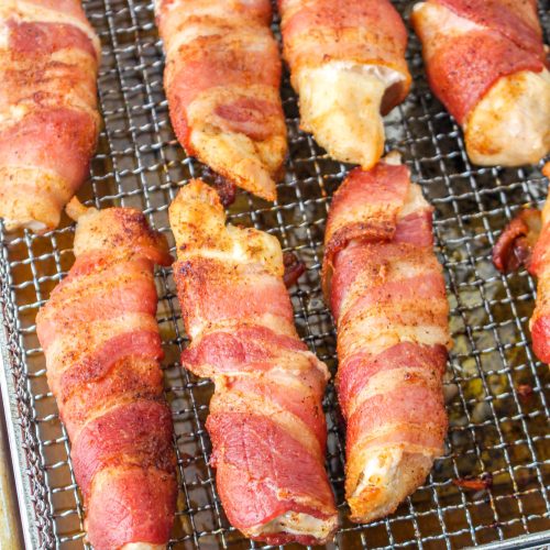 Air Fryer Bacon Wrapped Chicken Tenders on a cooling rack