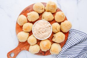 Cheeseburger Meatball Bomb Bites on a platter with sauce