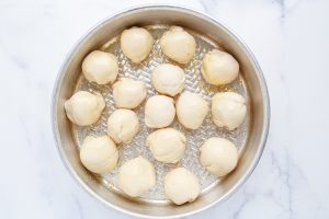 uncooked Cheeseburger Meatball Bomb Bites in a pan