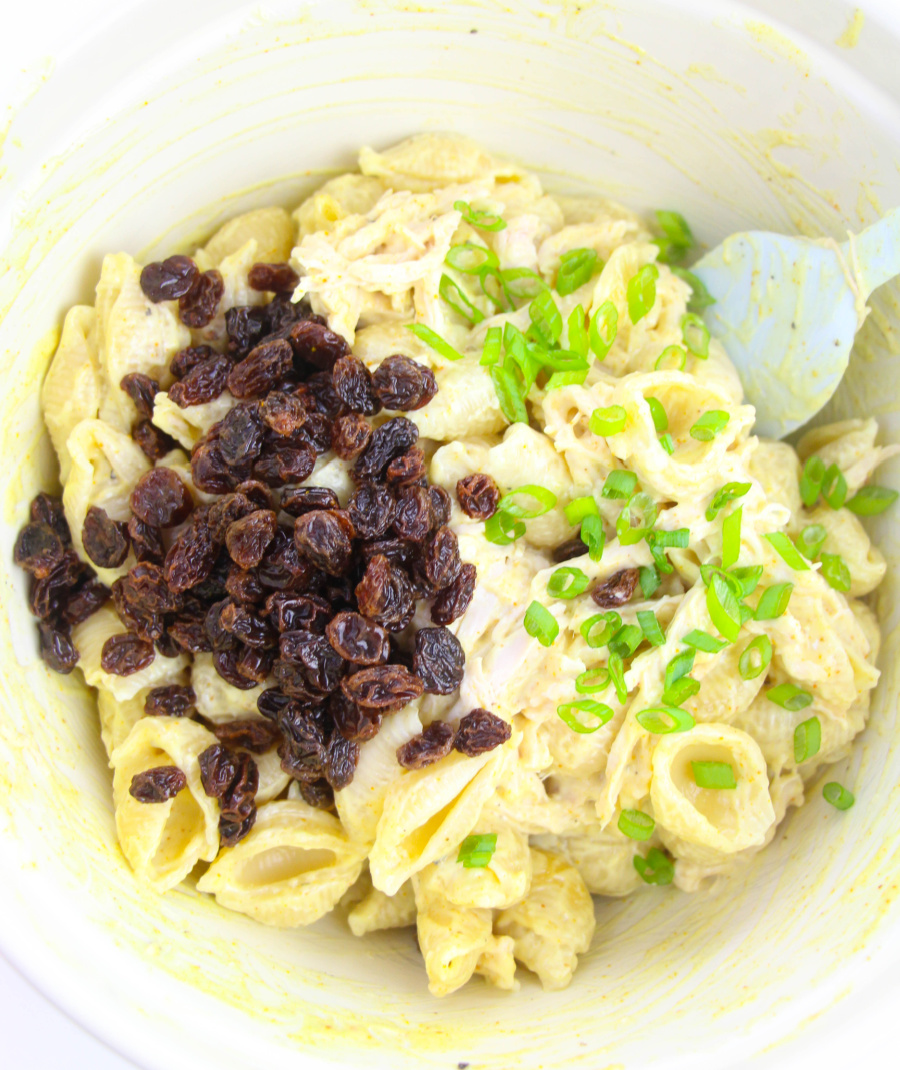 raisins, dressing and onions added to bowl