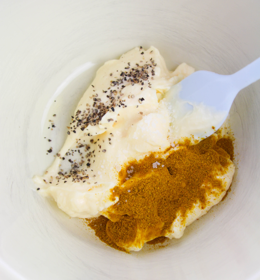 mayonnaise, curry powder, salt and pepper in a bowl