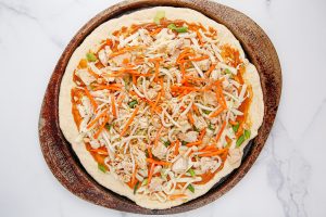 pizza toppings added to the pizza