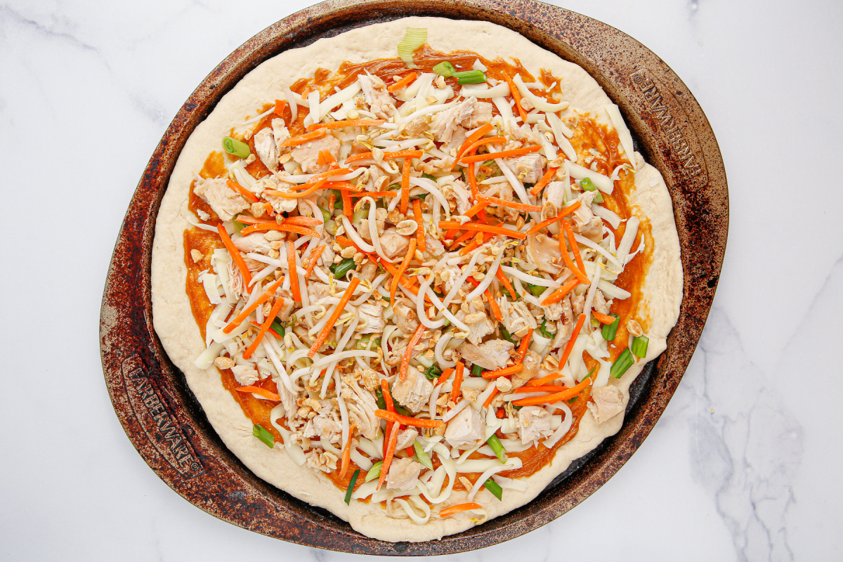 pizza toppings added to the pizza