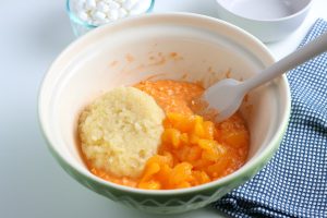 pineapple and oranges added to bowl