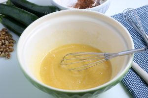 sugar, vanilla extract, oil and eggs mixed in a bowl