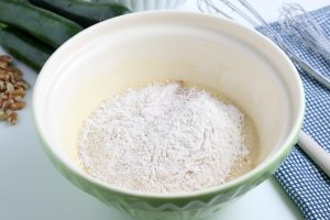 adding dry ingredients into bowl