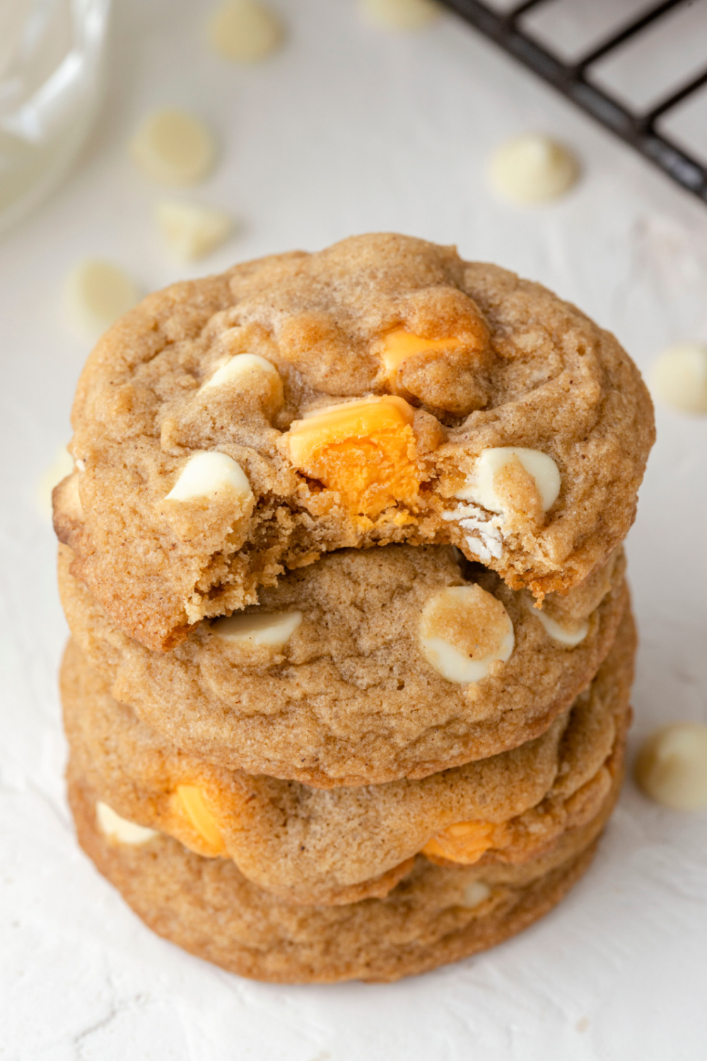 Pumpkin Spice White Chocolate Chip Cookies stacked on a table