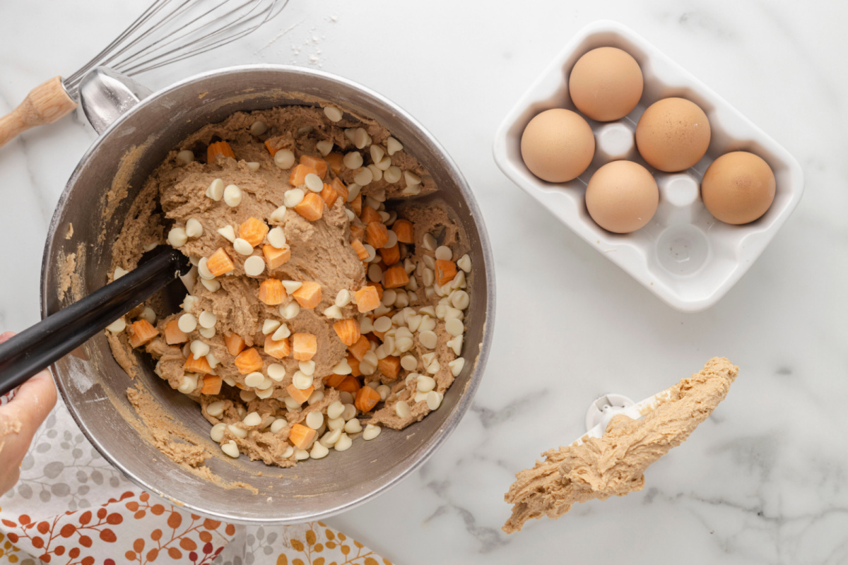 white chocolate chips and pumpkin spice chips added to mixing bowl