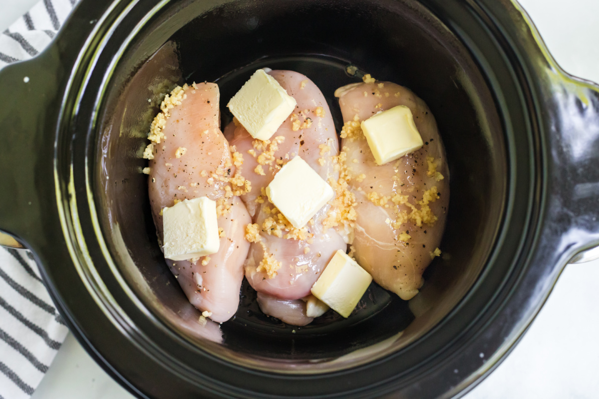 chicken with salt, pepper, and garlic in a slow cooker