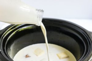 cream being added to slow cooker