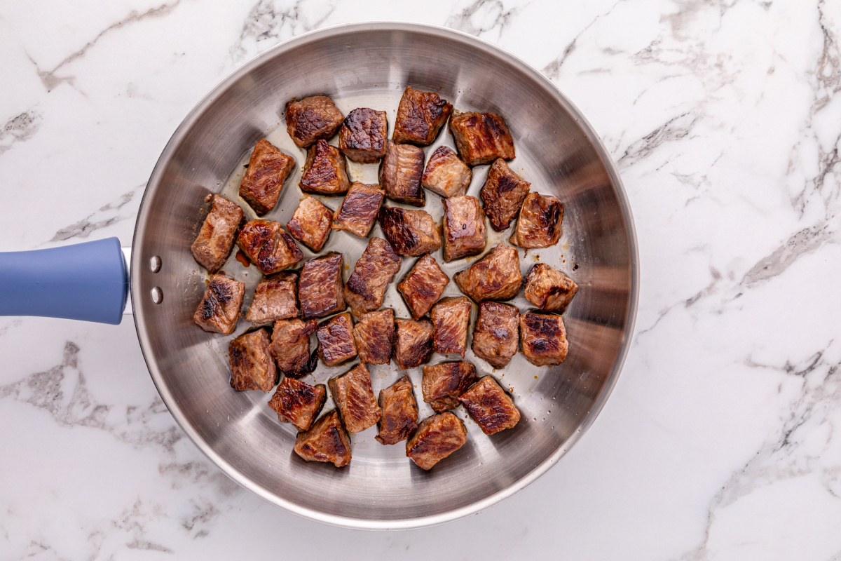 beef bites browned in a pan