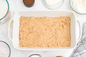 oatmeal cookie mixture pressed into baking pan
