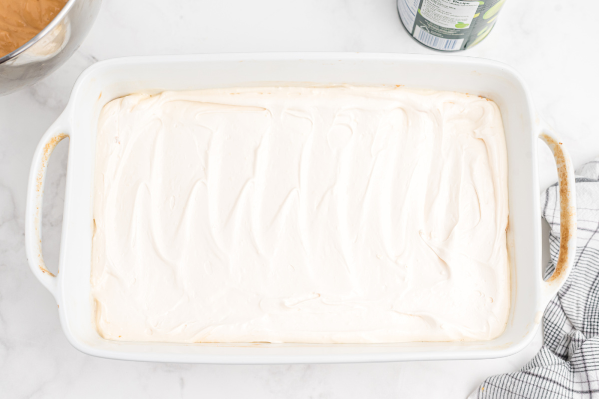 whip cream topping spread on top of cookie frust