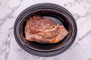 seared roast placed in slow cooker