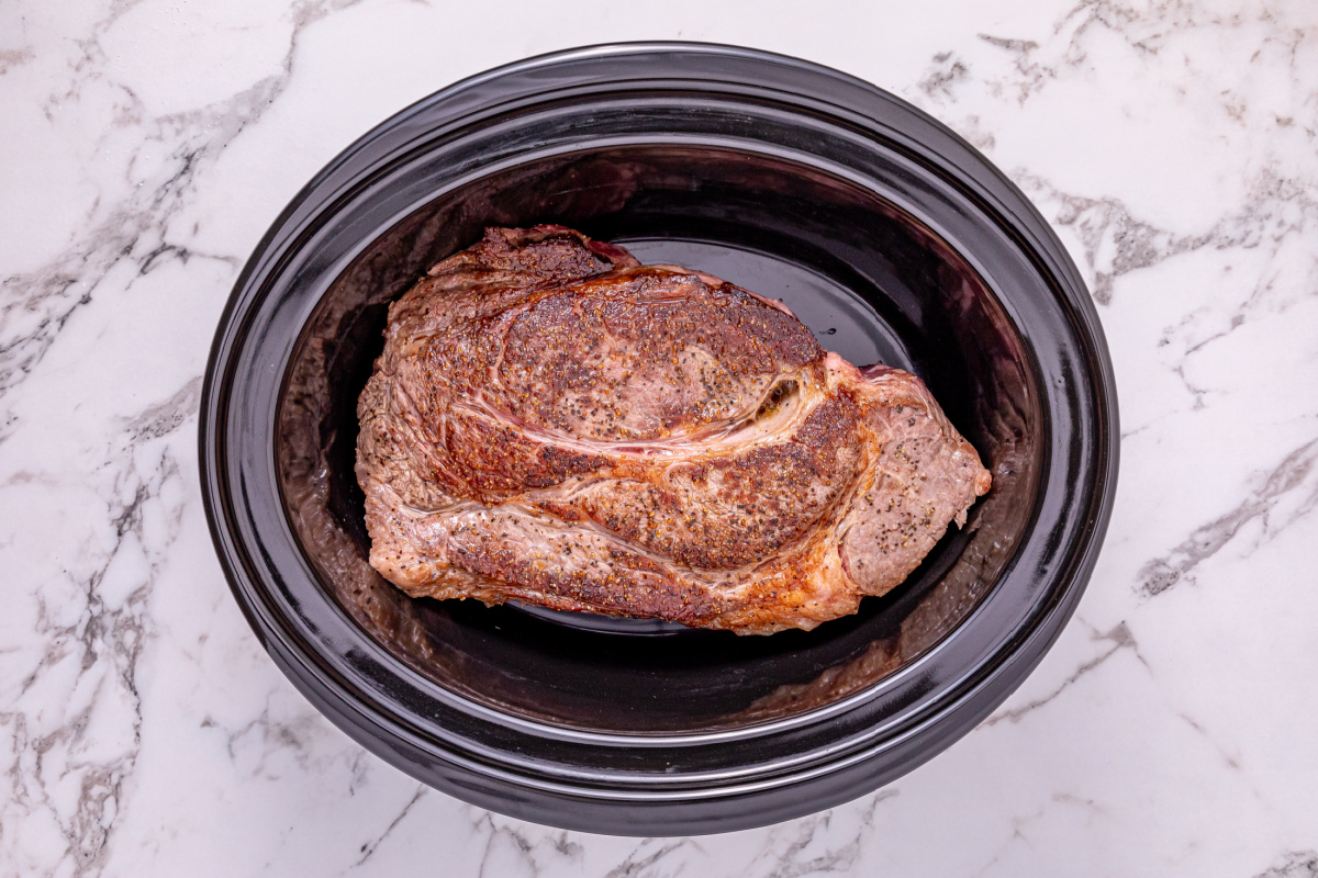 seared roast placed in slow cooker