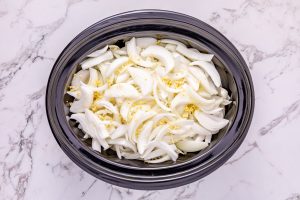 sliced onions and minced garlic added to top of beef